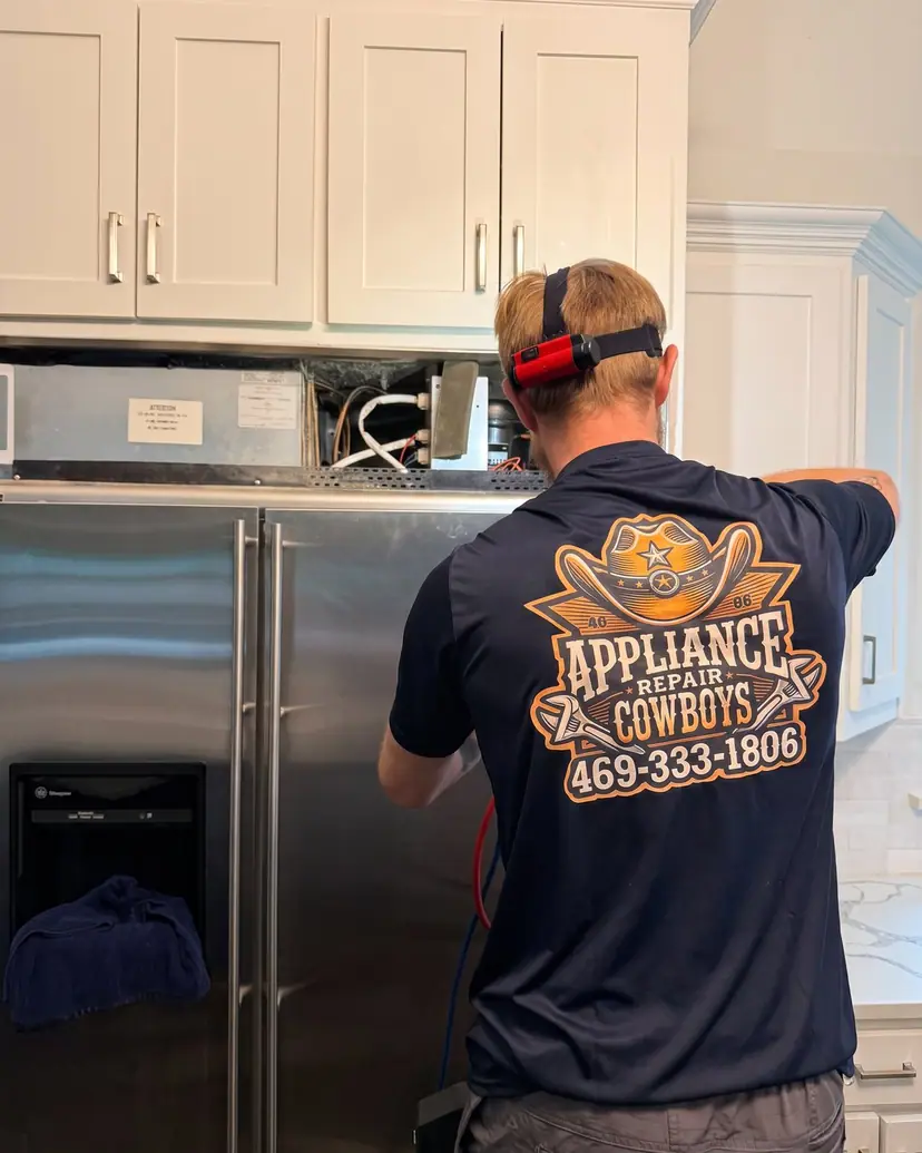 Appliance Repair Cowboys technician servicing the top compartment of a built-in stainless refrigerator